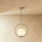 Clérachic larger silver ring pendant with a white opal glass globe resting in the lower ring, shown in a studio