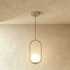 Clérachic taller silver oval ring pendant with a white opal glass globe at its base, hung on a cord in a studio
