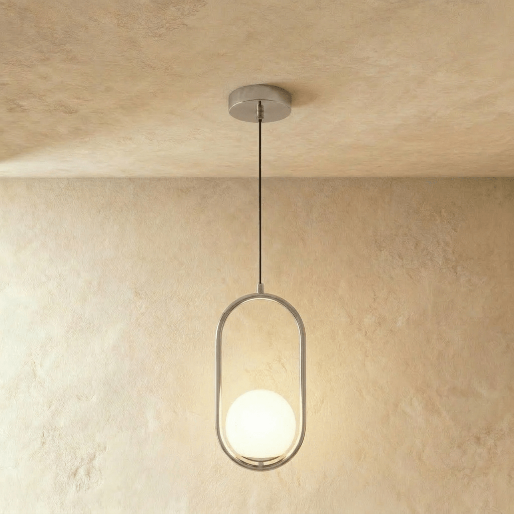 Clérachic taller silver oval ring pendant with a white opal glass globe at its base, hung on a cord in a studio