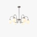 Polished chrome arms curl out from a central rod to frosted white glass globes on this Clérachic chandelier, on a white backdrop.