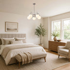 This Clérachic chandelier hangs in a bedroom with a tufted headboard, a throw over the bench and an olive tree at the corner.