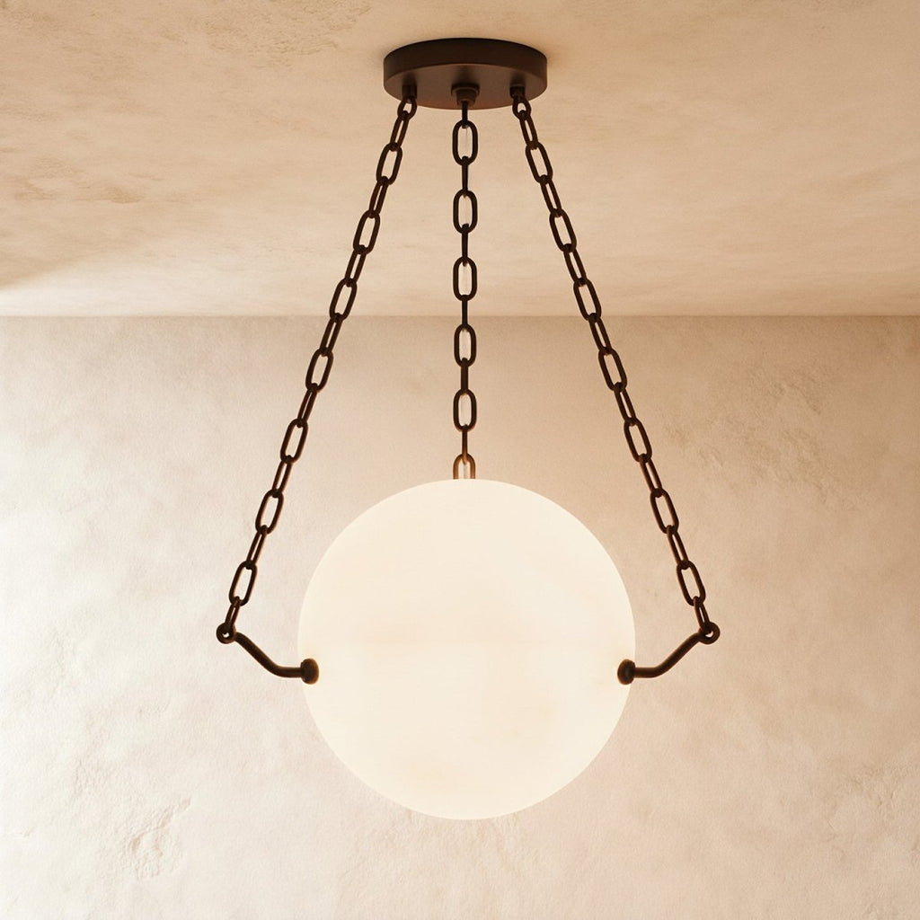 Clérachic alabaster globe pendant glowing softly, cradled by three bronze chains from a round bronze canopy