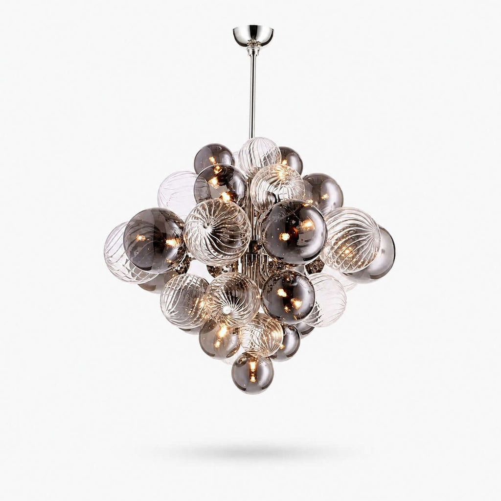 Globe pendant light from Clérachic, a cluster of smoked and ribbed clear glass spheres on a chrome rod, shown on white.