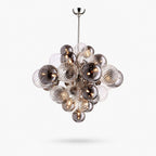 Globe pendant light from Clérachic, a cluster of smoked and ribbed clear glass spheres on a chrome rod, shown on white.