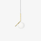 A compact Clérachic globe pendant on a pale backdrop, with a thin brass stem and a frosted ball that sits lower than the elbow.