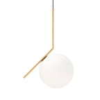 Studio shot of a large Clérachic globe pendant on white, with a slim brass stem bent at an angle over a smooth white glass ball.