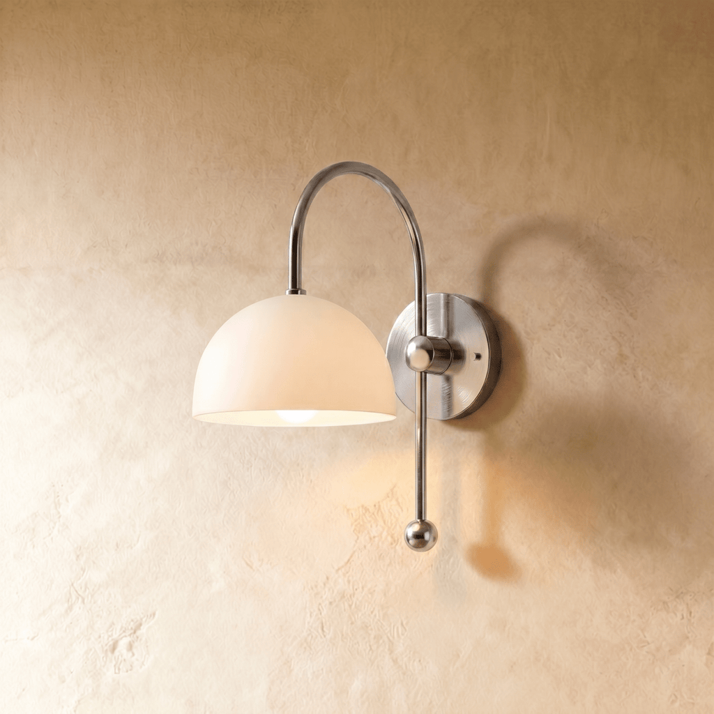 Clérachic wall lamp in chrome, its white dome shade curving from an arched arm and ball finial.