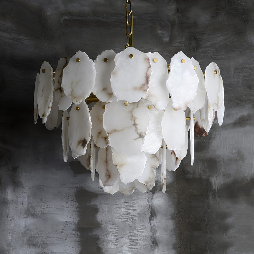 Angled view of the Clérachic Gloire chandelier where the alabaster veining runs grey and rose across the overlapping plates.