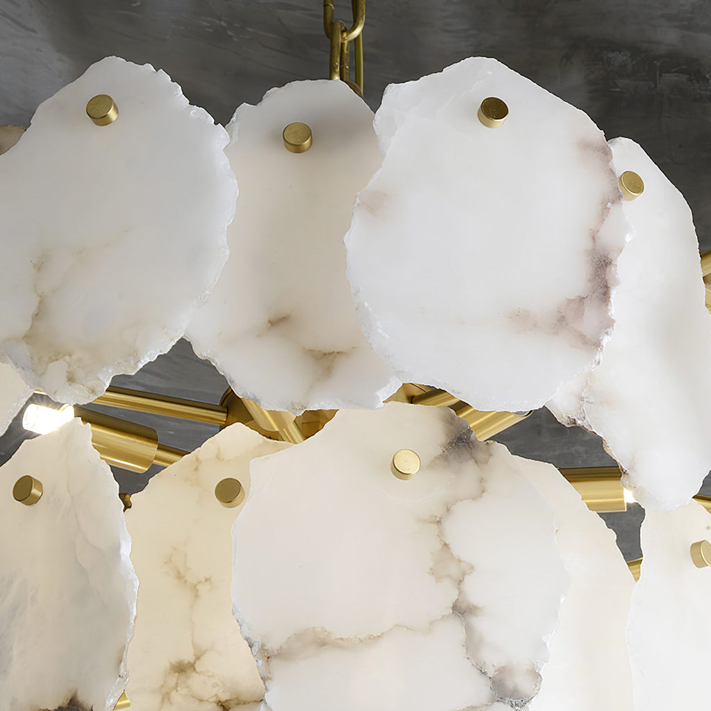 Looking up into the Clérachic Gloire chandelier at brass pins, brass crossbars and the soft veining on each alabaster plate.