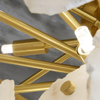 Inside the Clérachic Gloire chandelier: brushed brass tubing and two candelabra lampholders with their bulbs lit.