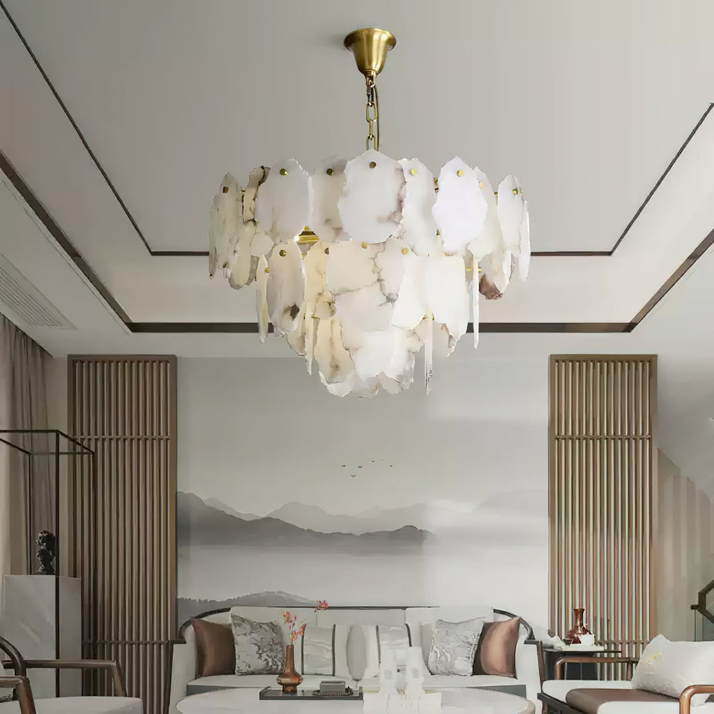 Clérachic Gloire chandelier hanging over a calm sitting room, its alabaster tiers echoing the ink landscape mural behind.