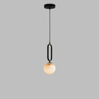 The Clérachic Gloruvyd pendant on a longer cord drop, its black metal fitting tapering into the alabaster ball.