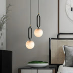 The Clérachic Gloruvyd pair steps down beside a cane headboard, alabaster globes warming a grey console below.