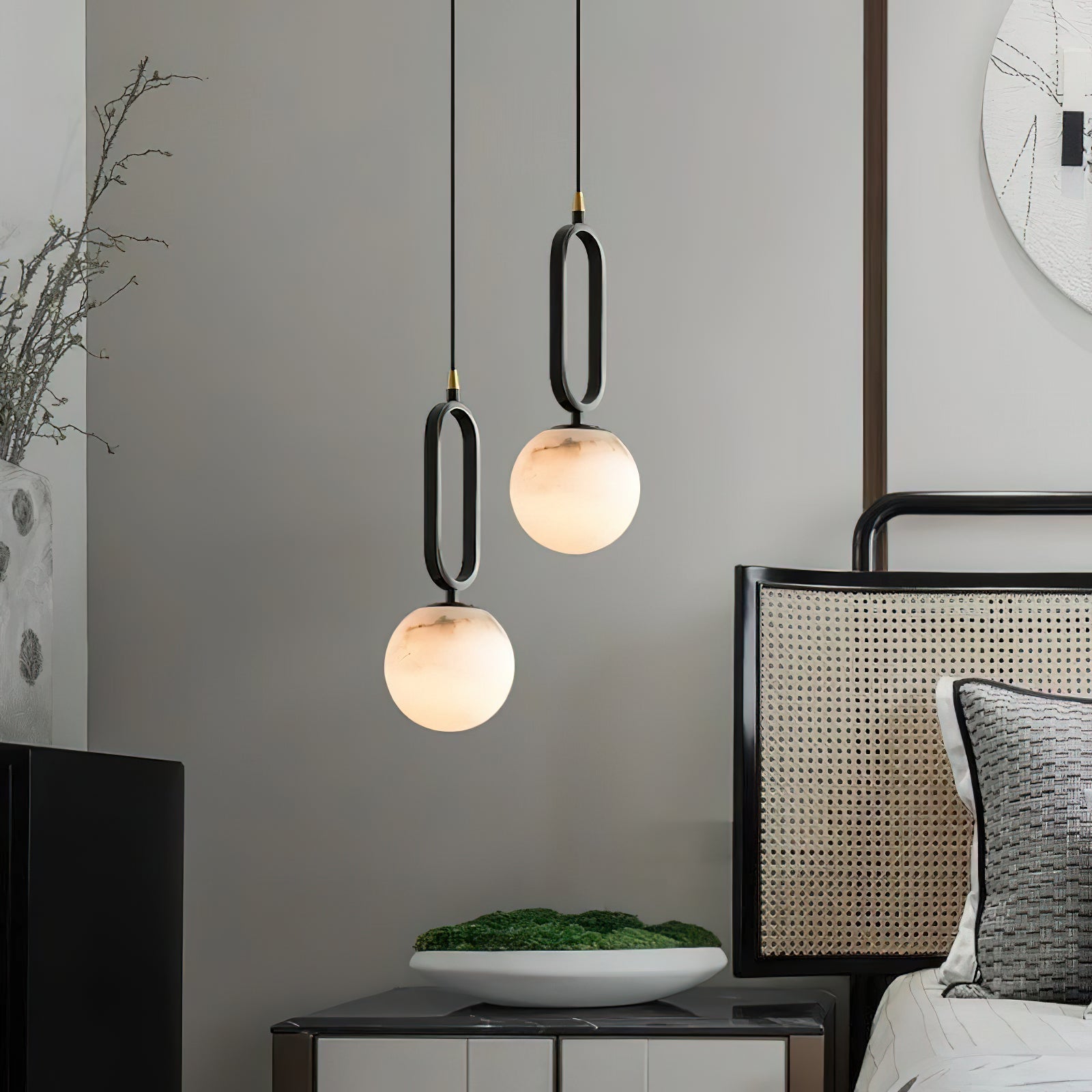 The Clérachic Gloruvyd pair steps down beside a cane headboard, alabaster globes warming a grey console below.