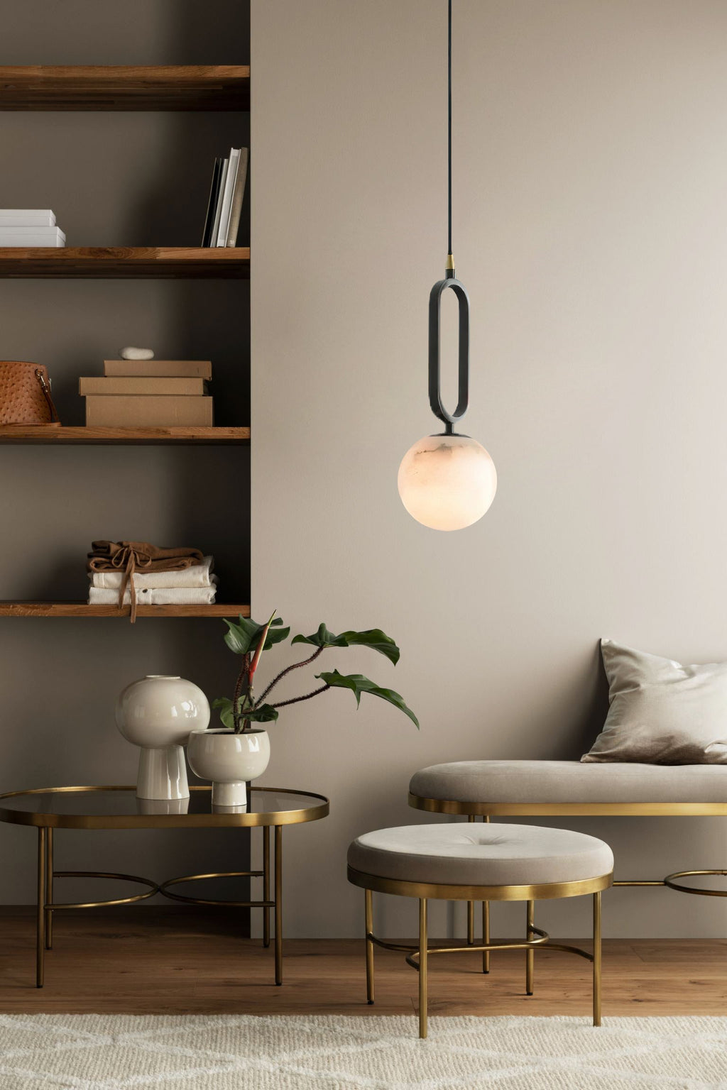 Clérachic Gloruvyd lights a reading corner, its alabaster globe glowing between built-in shelves and brass side tables.