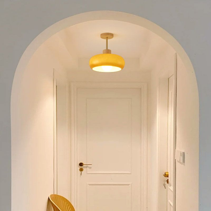 Clérachic dome ceiling light in glossy orange, mounted under an arched hallway opening above a panelled white door.