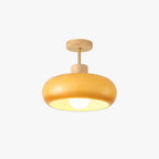 Clérachic glossy dome ceiling light in orange, shown against a plain studio backdrop with its wood canopy and brass rod.