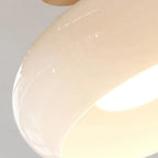 Close detail of the Clérachic white dome, showing the mirror-smooth glaze and the recessed lit underside.
