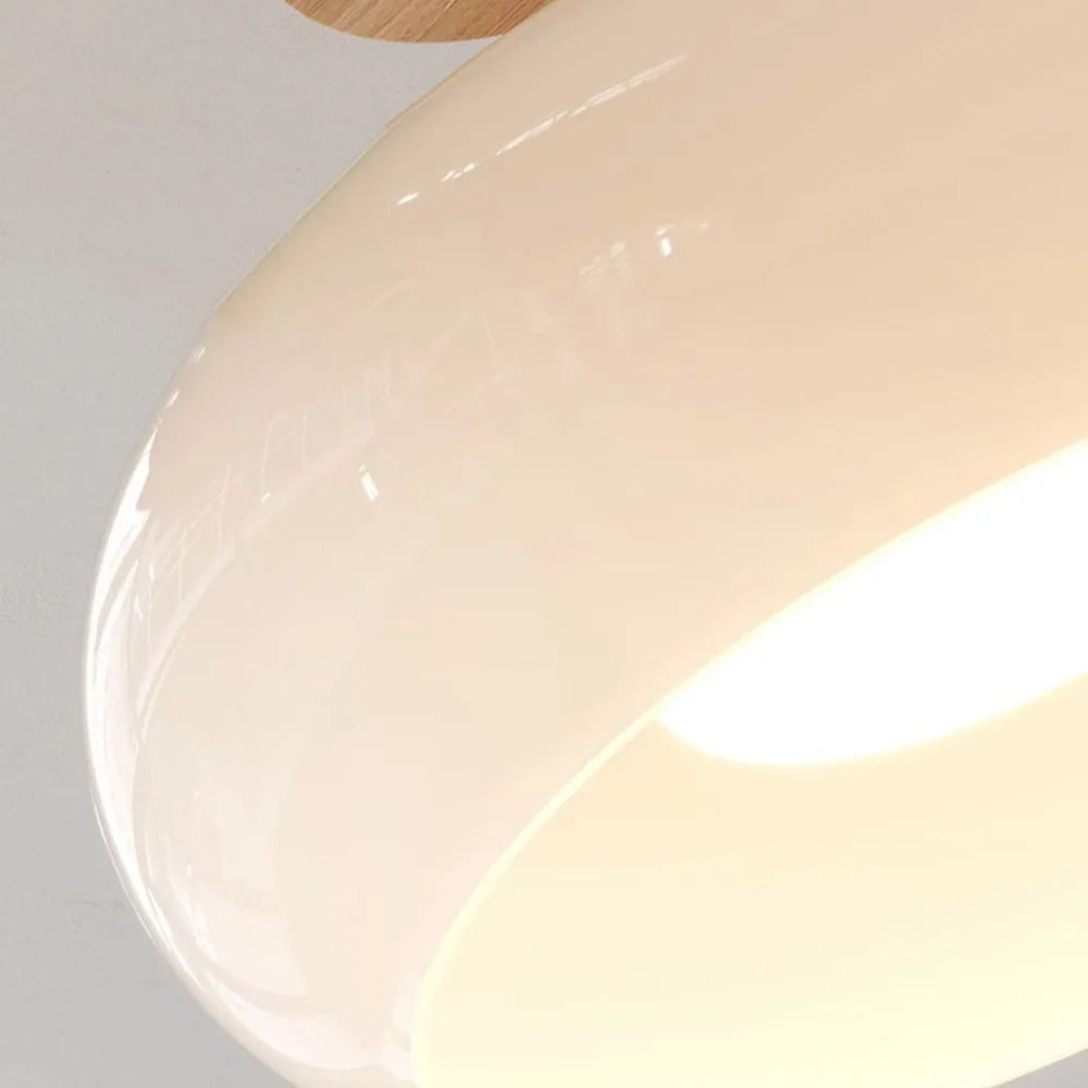 Close detail of the Clérachic white dome, showing the mirror-smooth glaze and the recessed lit underside.