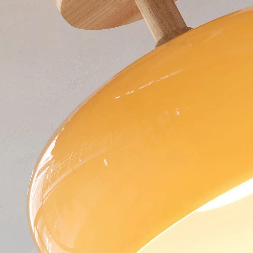 Close-up of the Clérachic yellow dome and its wood canopy, gloss reflections running across the curve.