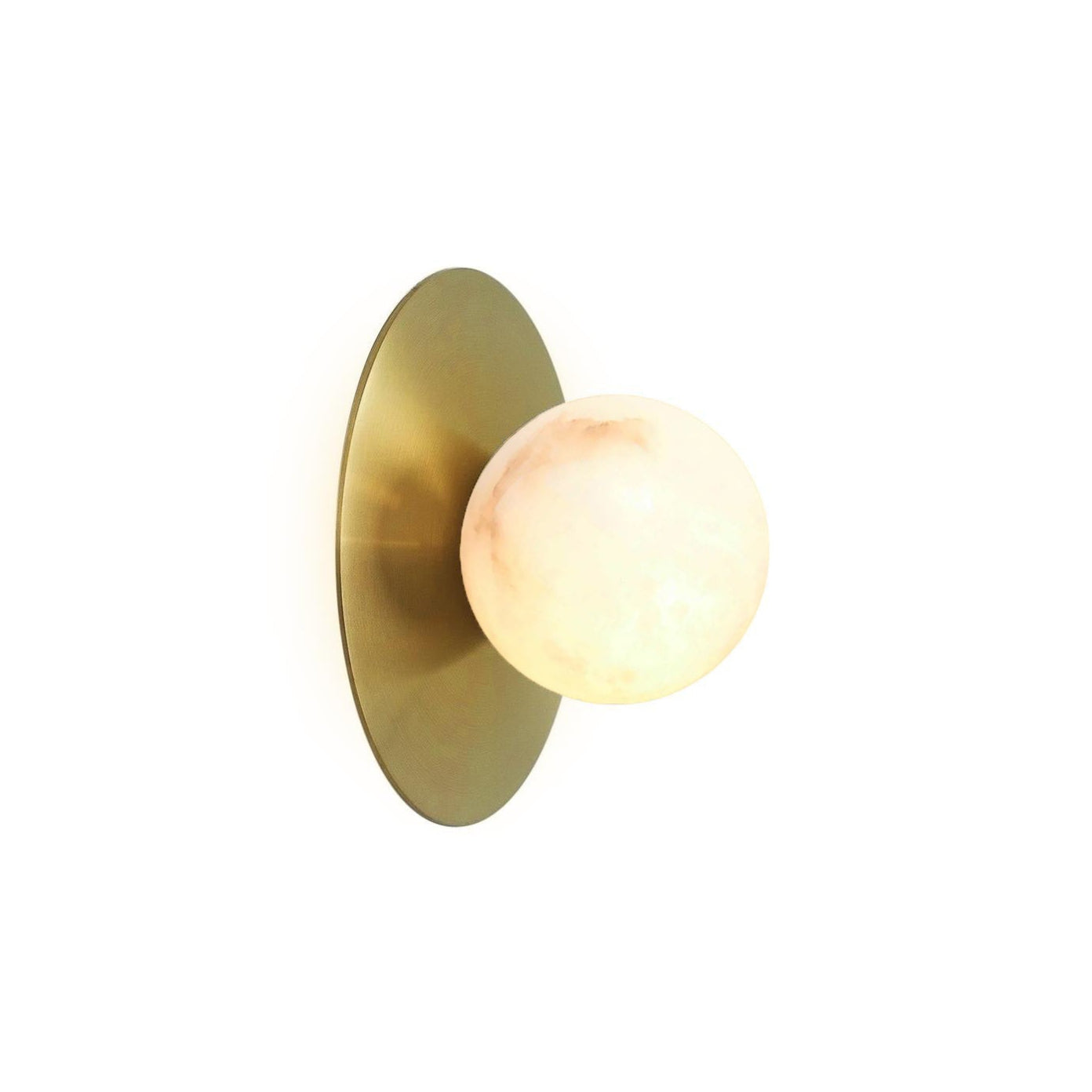 The Clérachic Glow sconce lit on white, warm light glowing through the alabaster sphere.