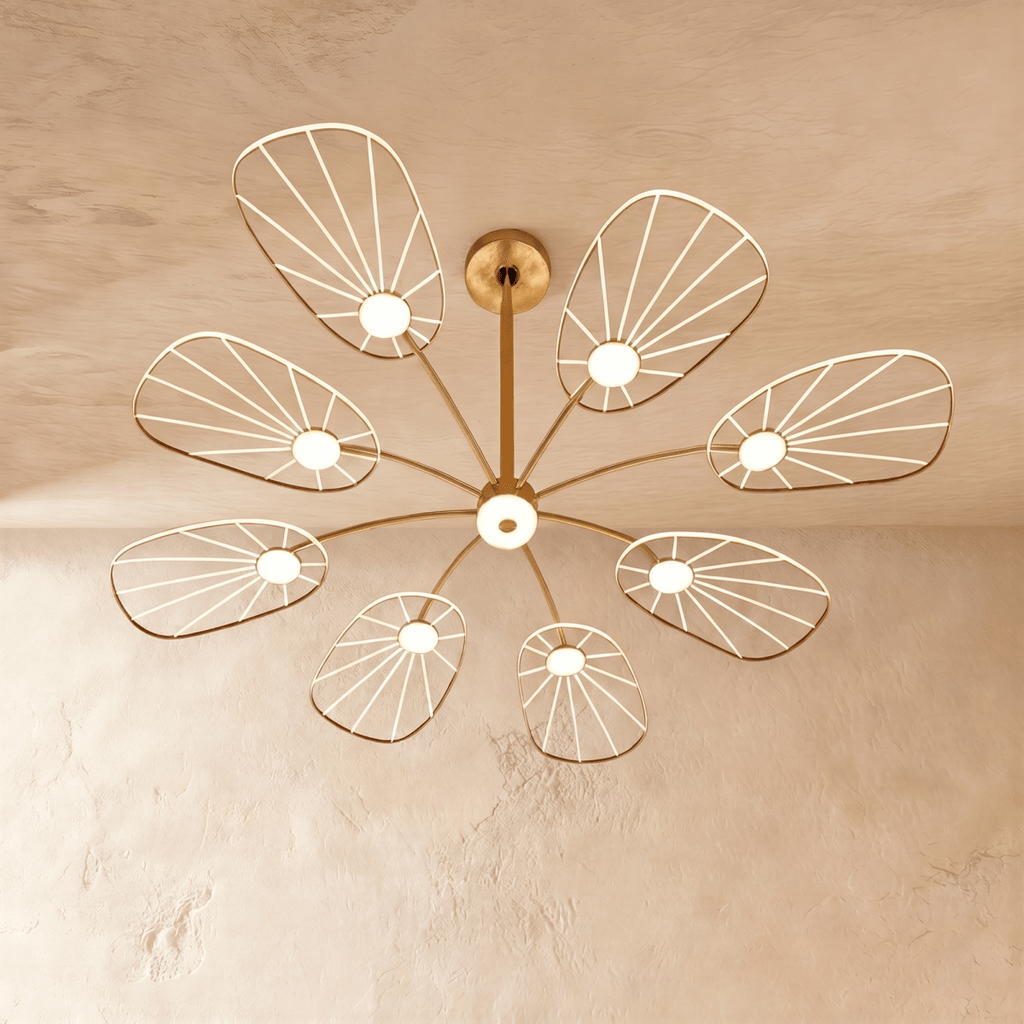 Clérachic leaf-shaped chandelier with 8 lit acrylic panels fanned out from a brass centre stem on a plaster ceiling.