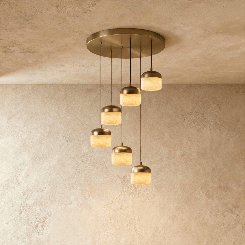 Clérachic alabaster pendant light in the 6-light cluster, glowing stone shades cascading from a round brass canopy.