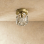 Clérachic small ceiling light with a clear faceted crystal shade and a matte brass-toned plate, unlit on limewash.