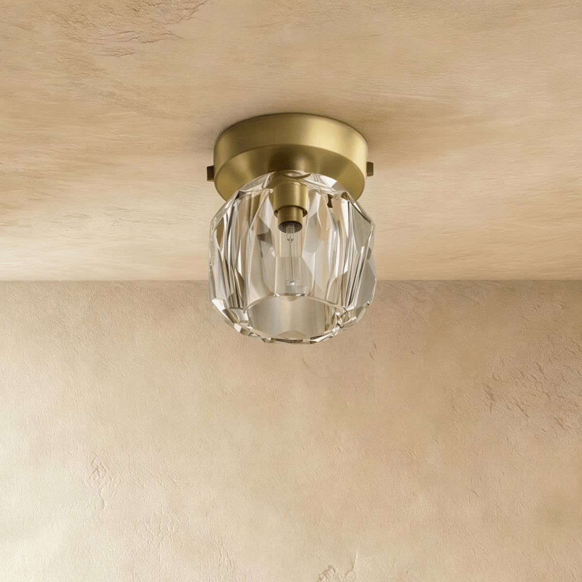Clérachic small ceiling light with a clear faceted crystal shade and a matte brass-toned plate, unlit on limewash.