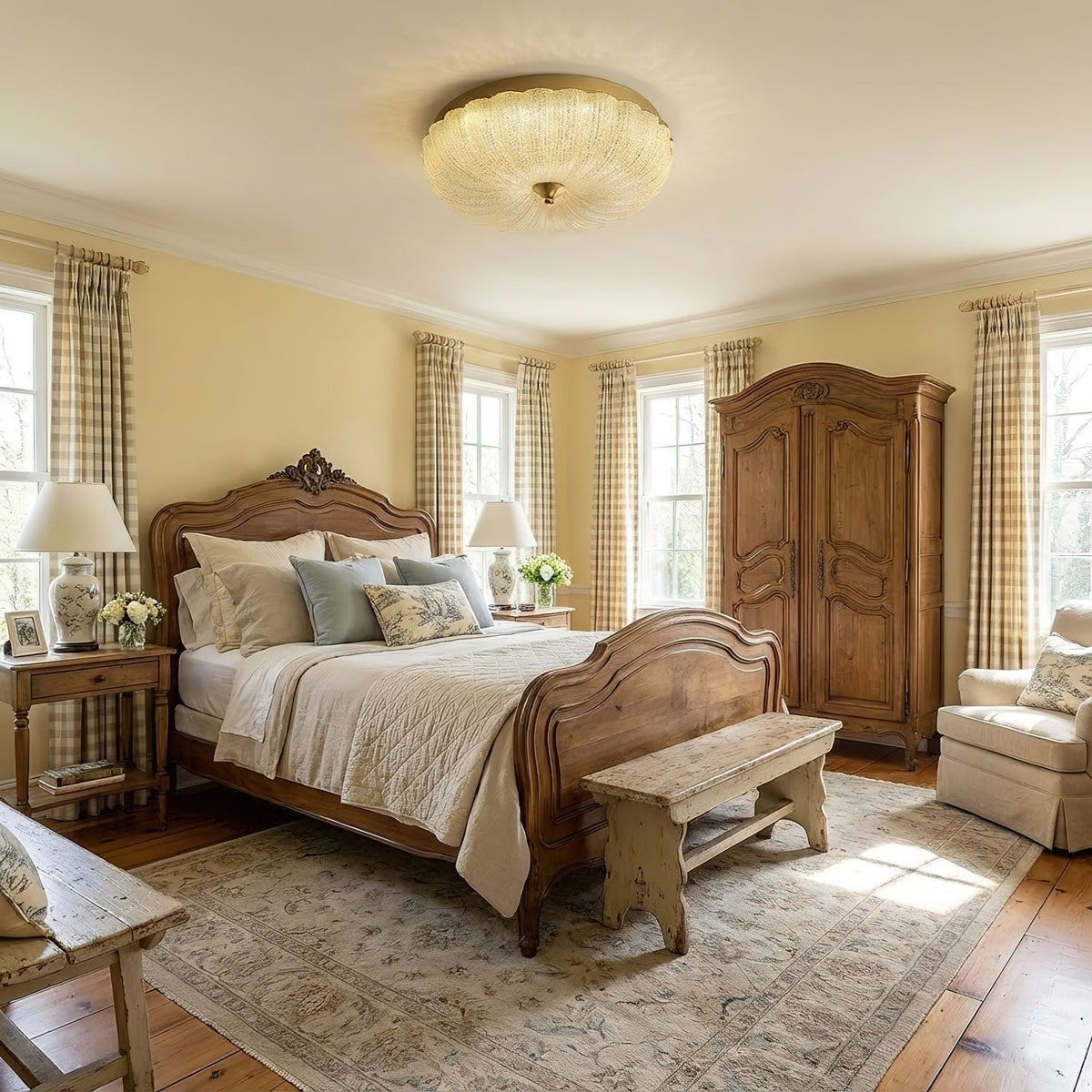 Lit Clérachic flush ceiling light with a ribbed glass shade over a bedroom with a carved wooden bed, a wardrobe and a patterned rug.