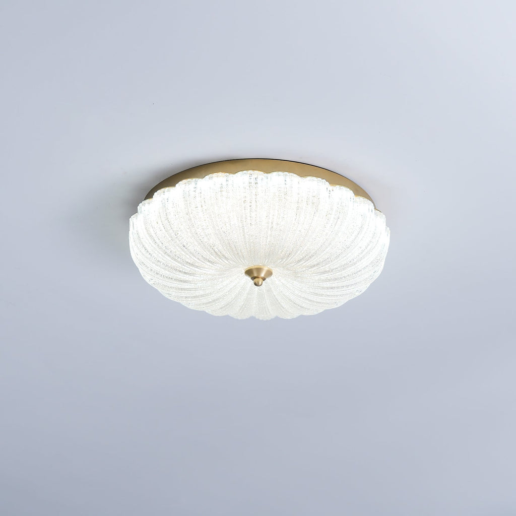 Clérachic flush ceiling light with a frosted, ribbed glass shade lit white, on a pale lavender-grey ceiling.