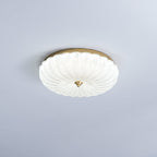 Clérachic flush ceiling light with a frosted, ribbed glass shade lit white, on a pale lavender-grey ceiling.