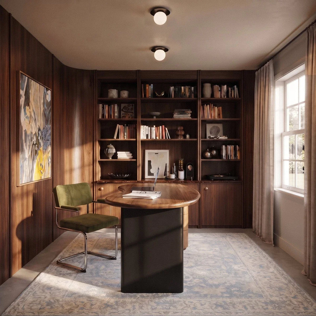 Two Clérachic ceiling lights in black, glowing above a walnut-paneled home office with a round desk.