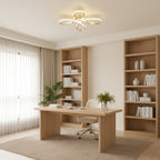 A Clérachic ceiling light above a pale wooden desk in a home study, with open bookshelves, a green plant and sheer curtains.