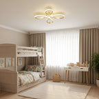 Clérachic ceiling light glowing over a child's bedroom with a wooden bunk bed, a small white desk and soft beige curtains.