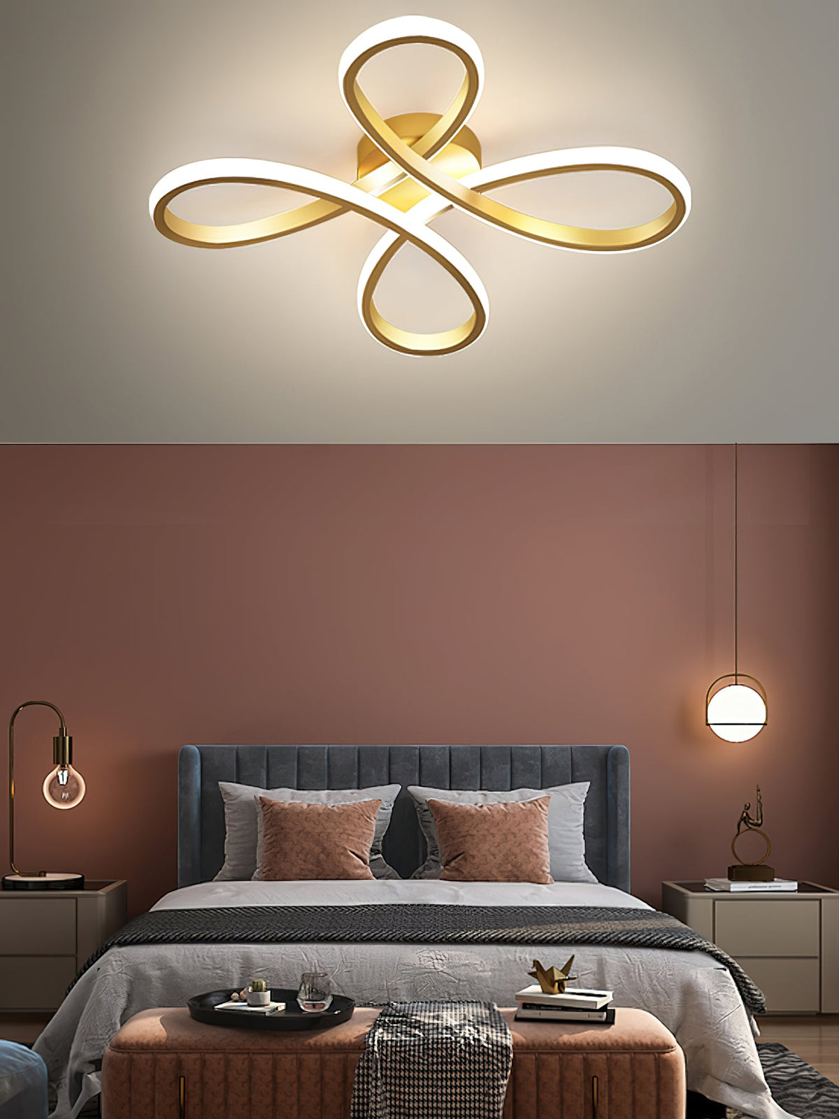Close view of the Clérachic gold ceiling light above a bedroom with a terracotta wall, a blue-grey headboard and two small pendants.