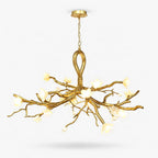 A Clérachic chandelier with gold metal branch arms rising from a looped centre and lit ceramic blossoms, shown on a plain white backdrop.