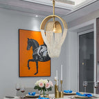 Clérachic single-head gold and crystal bead pendant with one candle bulb, hung over a dining table set with candles and flowers.