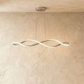 Clérachic chandelier in chrome, its twisting ribbon of light suspended from a plaster ceiling.