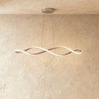 Clérachic chandelier in chrome, its twisting ribbon of light suspended from a plaster ceiling.