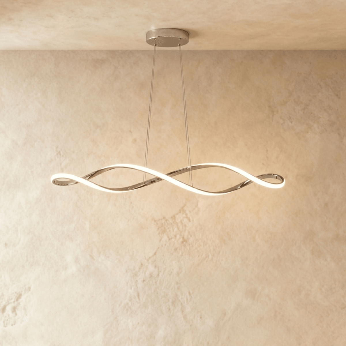 Clérachic chandelier in chrome, its twisting ribbon of light suspended from a plaster ceiling.