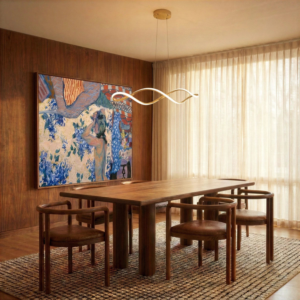 A Clérachic chandelier in gold lights a dining table beneath sheer curtains and a bold painting.
