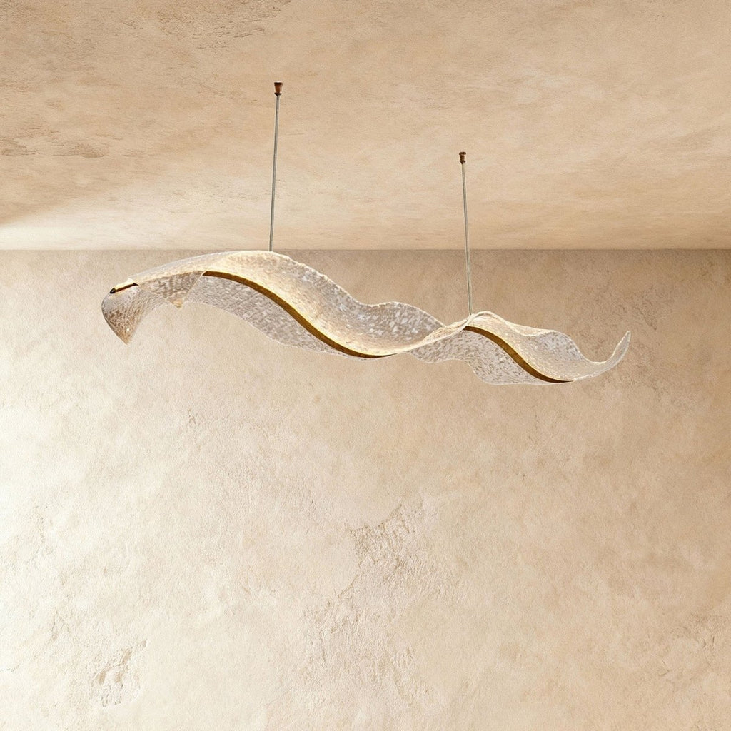 This Clérachic ribbon chandelier curls into a flowing double wave, its surface catching warm ambient light.