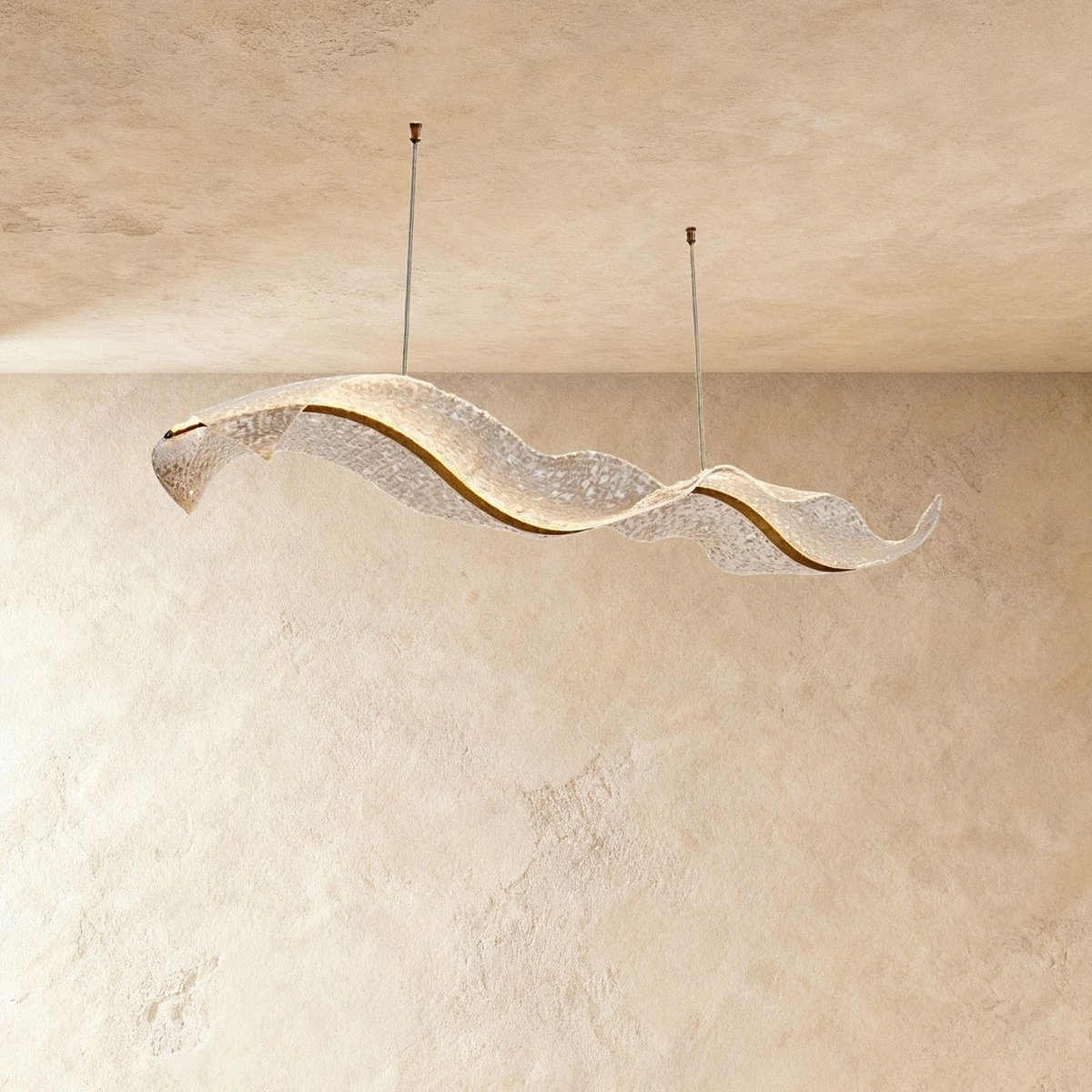 This Clérachic ribbon chandelier curls into a flowing double wave, its surface catching warm ambient light.