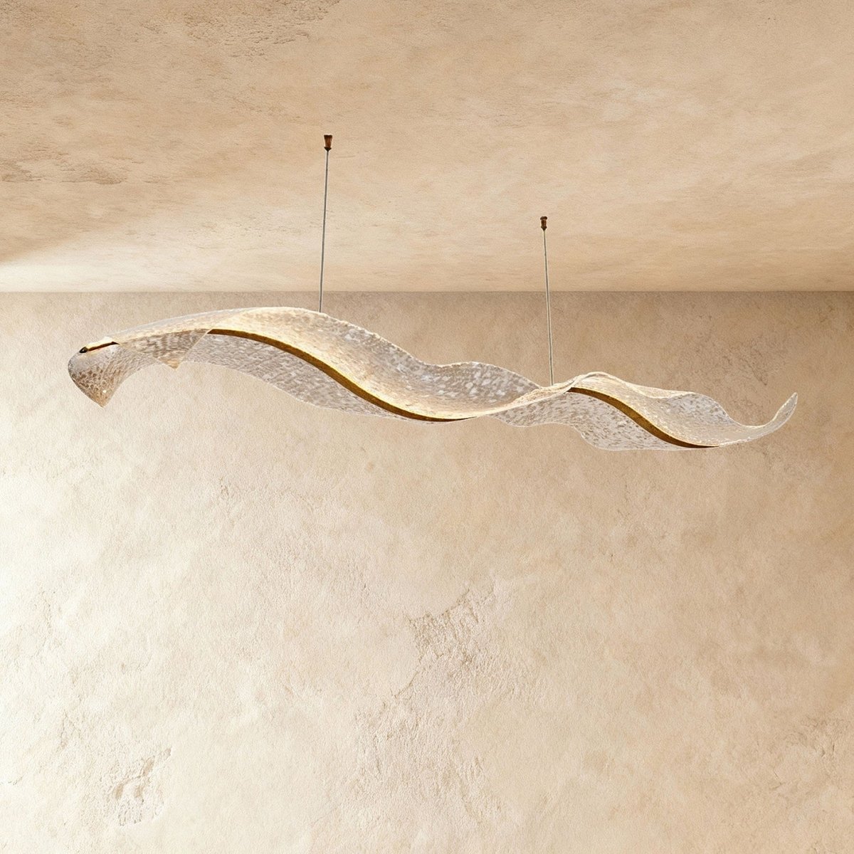 This Clérachic wave-form chandelier curves gently, its rippled acrylic panels lit against plaster tones.