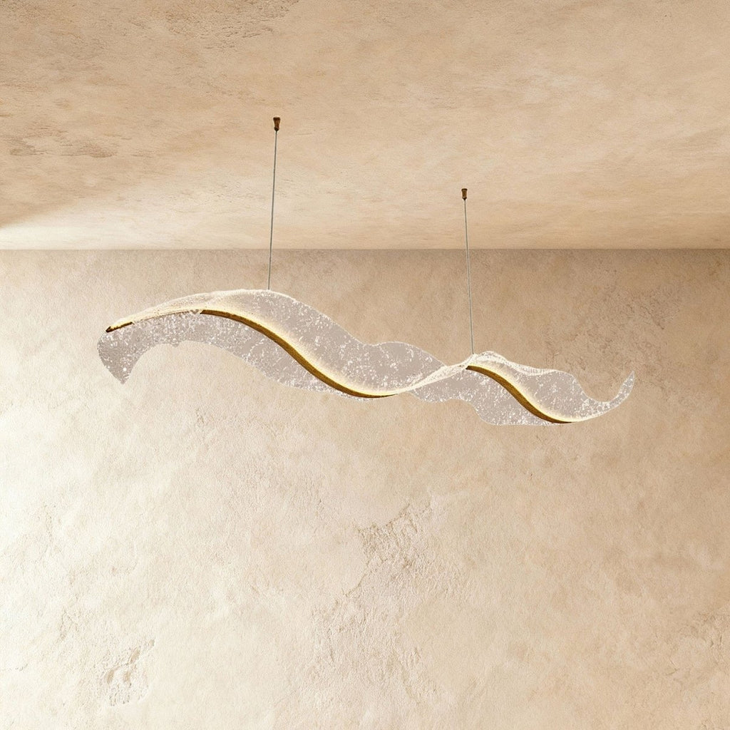 This Clérachic ribbon-form chandelier sweeps into a long wave, its textured surface softly backlit.