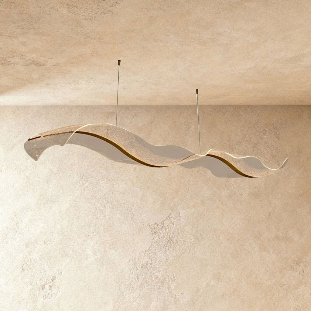 This Clérachic sculptural chandelier curves in a long double wave against a warm plaster backdrop.