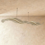 This Clérachic wave chandelier shows a smoother frosted acrylic finish along its curved form.
