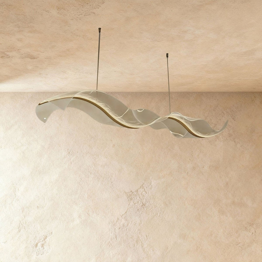 This Clérachic sculptural chandelier's frosted acrylic panels curve smoothly against a plaster wall.
