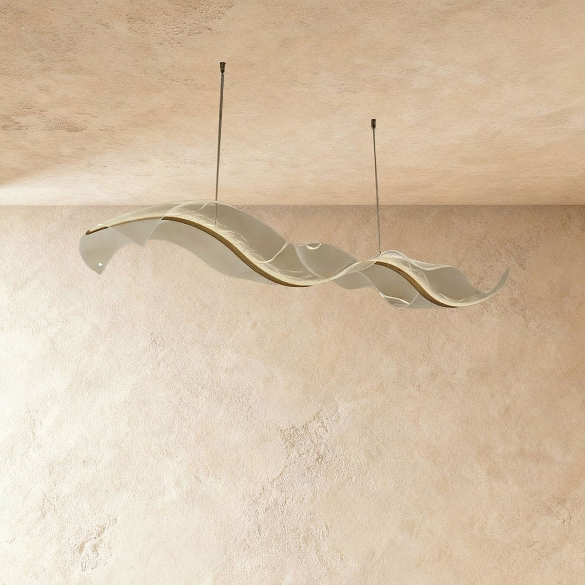 This Clérachic sculptural chandelier's frosted acrylic panels curve smoothly against a plaster wall.